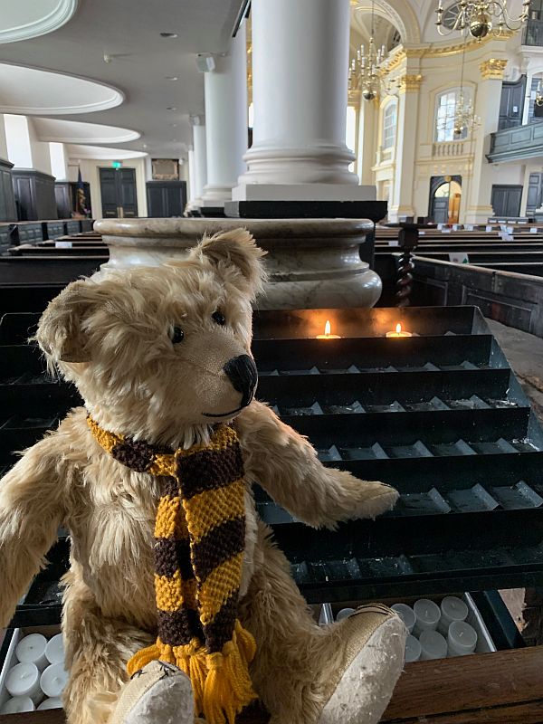 Bertie in St-Martin-in-The-Fields Church with candles lit for Diddley and Peter.