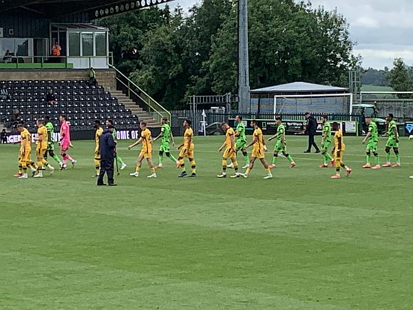 Sutton United in yellow and Forest Green in green emerge onto the pitch.