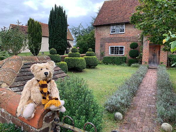 Bertie, wearing his Sutton United Scarf, outside Wisley Church Farm House.