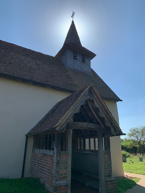 The church ast Wisley, with the Sun creating a halo around the spire.