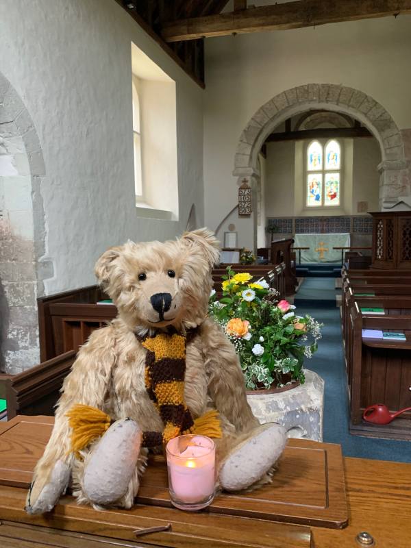 Bertie in Wisley Church with a candle lit for Diddley.