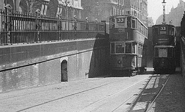 Two No33 trams - one ascending from, the other descending into, the Kingways Tram Tunnel.