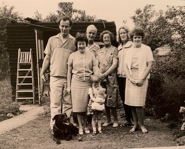 Family shot with the dog Jack lying in front.