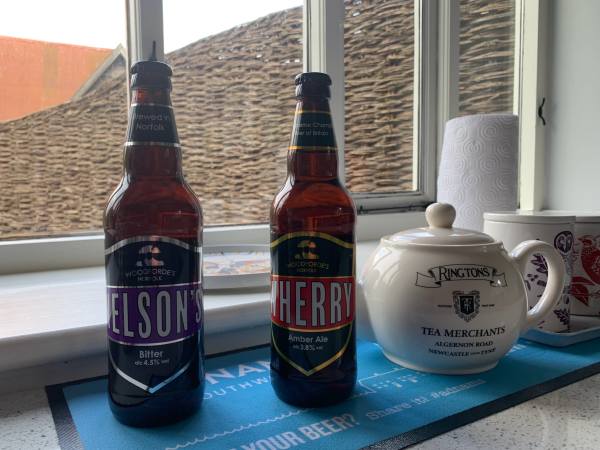 Welcome gifts of two bottles of Norfolk beer on the window cill.