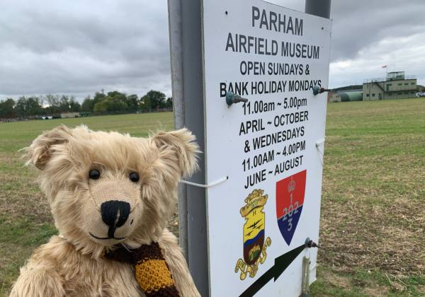 Bertie by the sign for Parham Airfield Museum.