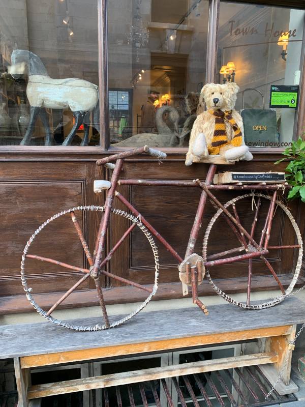 Bertie sat on an old bike outside The Townhouse, Fournier Street, Spitalfields.