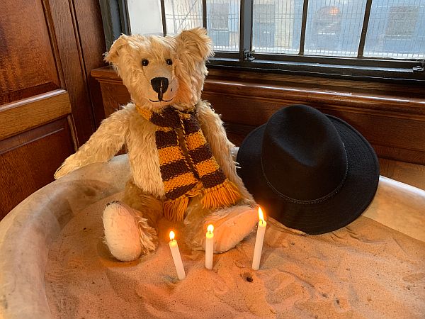 Bertie, with three candles lit for Diddley, AMber and Peter, in Christ Church, Spitalfields.