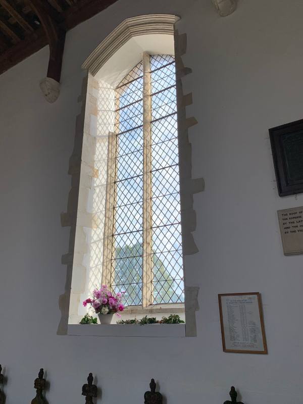 One of the plain, but tall, windows, that make the church light and airy.