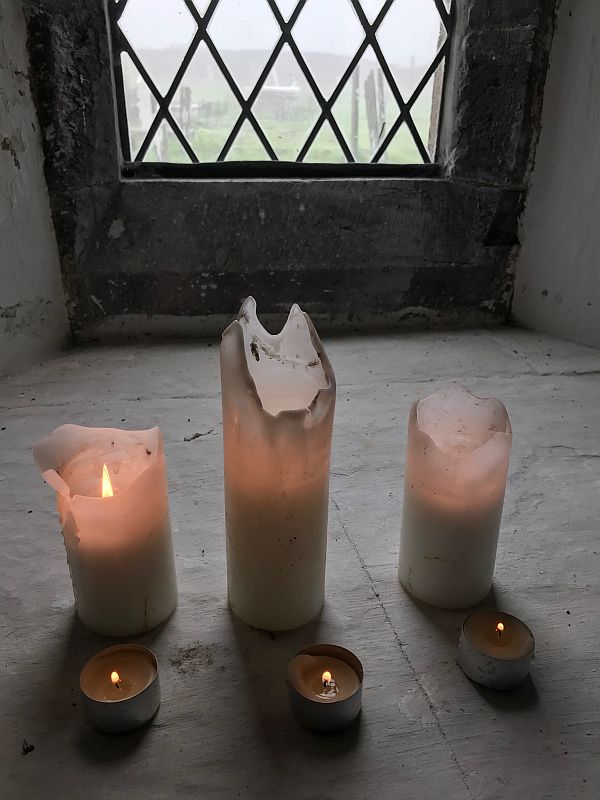 Three candles. Lit for Diddley and Rosemary.