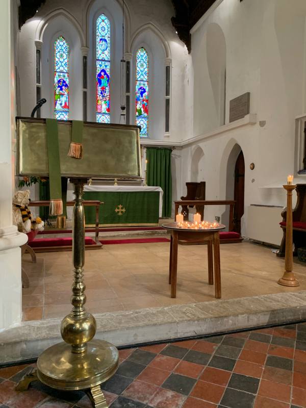 Bertie looking on at the candles in the chancel.