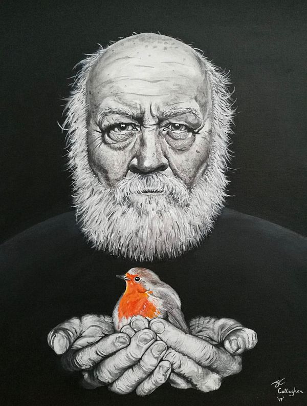 A black-and-white picture of a bearded man hold a Robin in his cupped hands. Only the chest of the Robin has colour.
