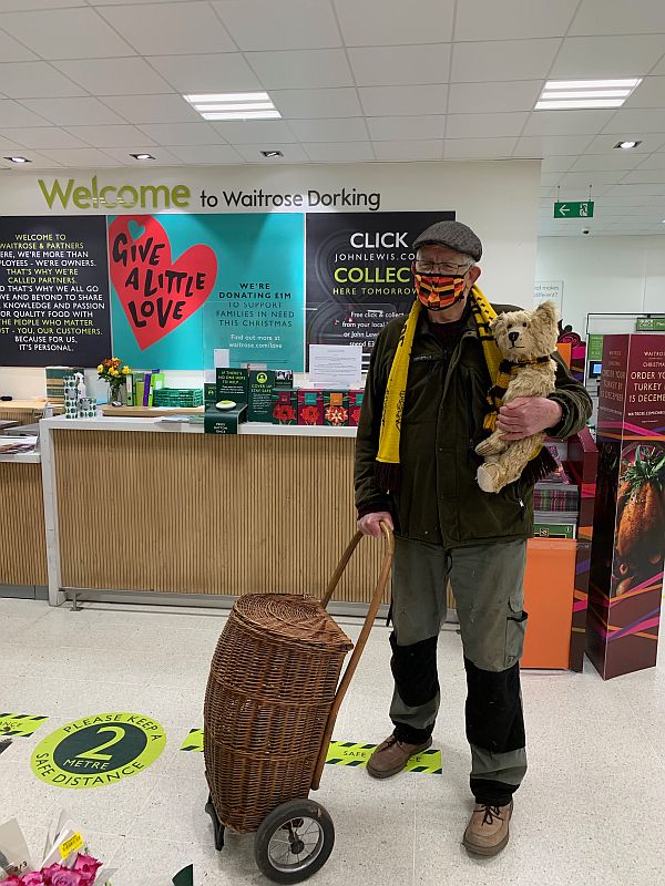 Bobby, with his colourful face-mask, holding Bertie and with Bobby 2 at the reception desk in Waitrose.