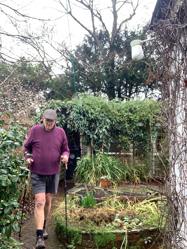 Bobby with his walking poles in the garden at Laurel Cottage.