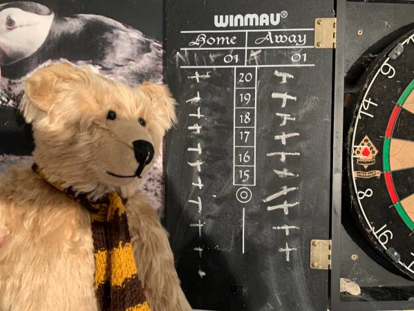 Bertie by the dart board.