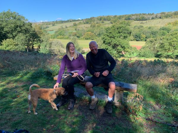 Steph, Rob sat on The Bench with Harley the dog in front.