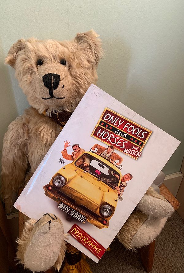Bertie holding an "Only Fols and Horses - The Musical" Programme.