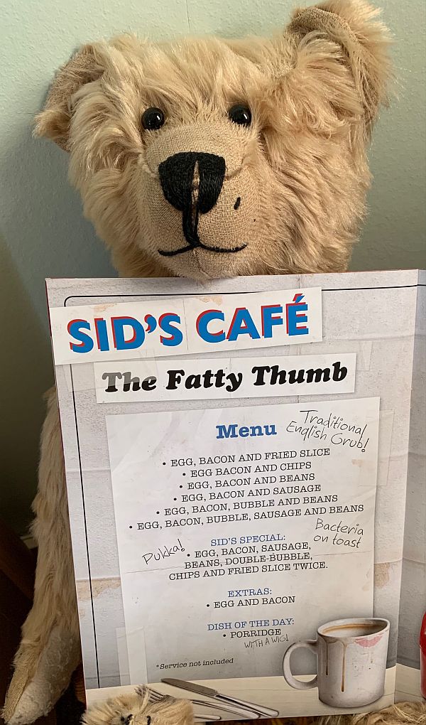 Bertie with the Sid's Café menu from the programme.