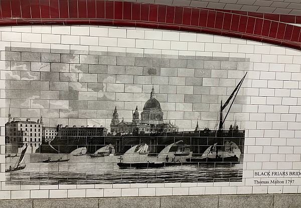 Black and white mural looking towards St Paul's across the Thames, which has a number of sailing boats heading upstream.