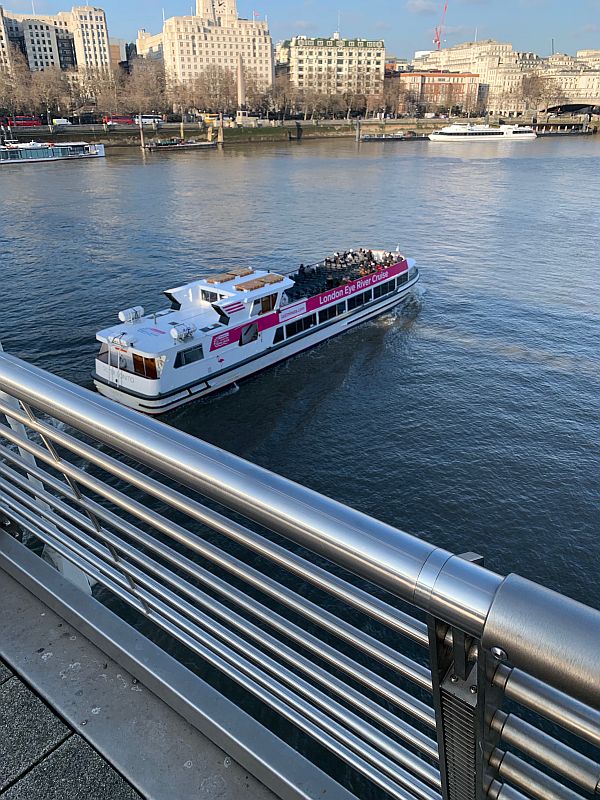 View of a Thames Cruiser emerging from under the Jubilee Bridge.