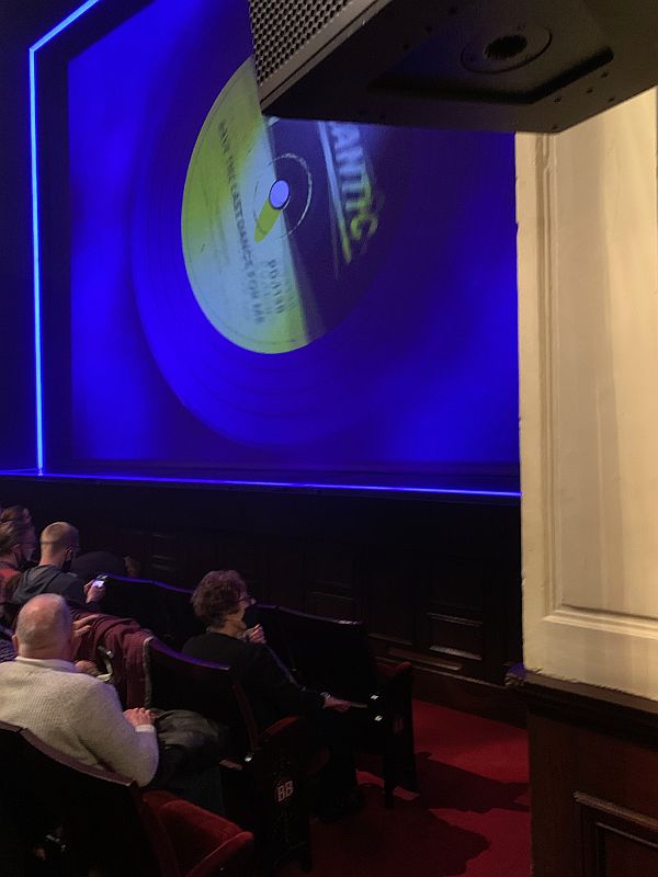 View inside the theatre, with an Atlantic record showing on the screen.