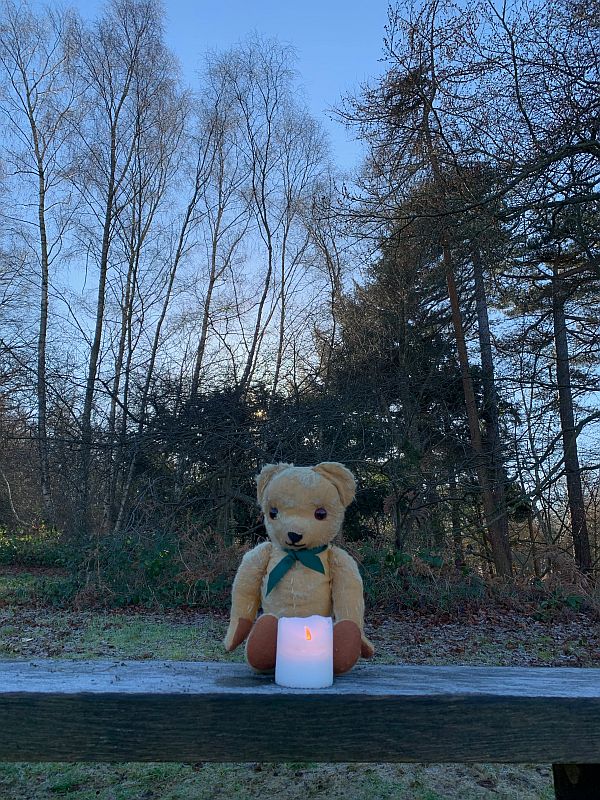 Eamonn with a candle lit for Diddley on the bench at Abinger Roughs.