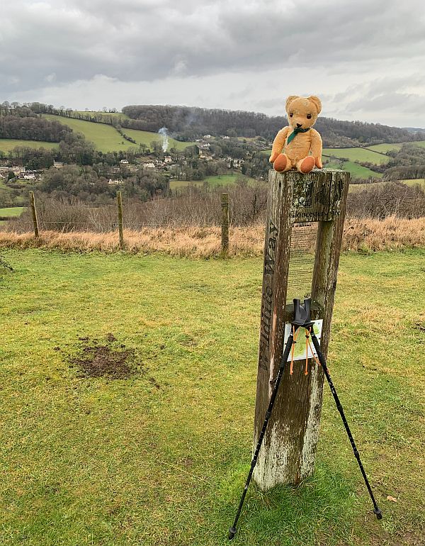 Eamonn sat on a Laurie Lee Poetry Post on Swift's Hill.