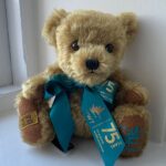 Bewick Bear. A small, fluffy bear with a light blue scarf printed "WWT: 75 years for Wetlands, Wildlife & People".