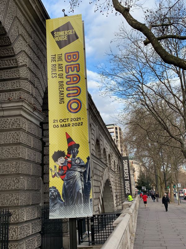 The exterior of Somerset House, with the "BEANO - The Art of Breaking the Rules" pennant hanging vertically.