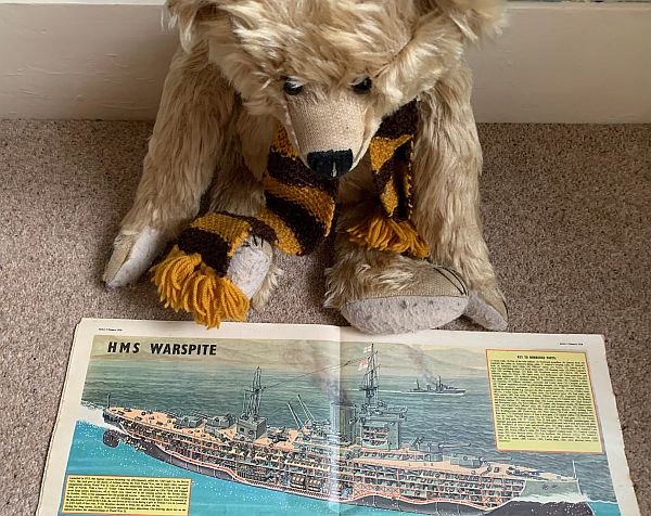 Bertie studying a "cutaway" picture of HMS Warspite.