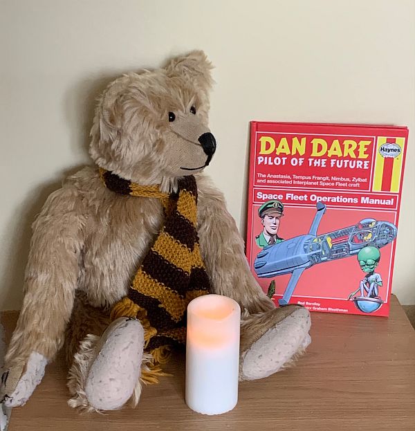 Bertie, with a Candle lit for Didley alongside a Haynes Manual "Space Fleet Operations Manual"
