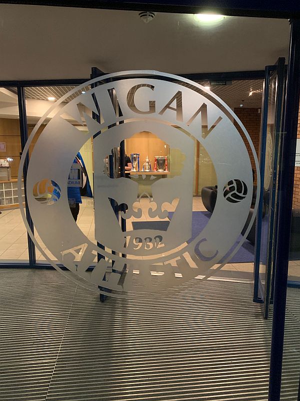 Window with Wigan Athletic 1932 frosted on it.