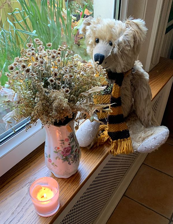 Bertie sat alongside the "letterbox flowers" with a candle lit for Diddley.