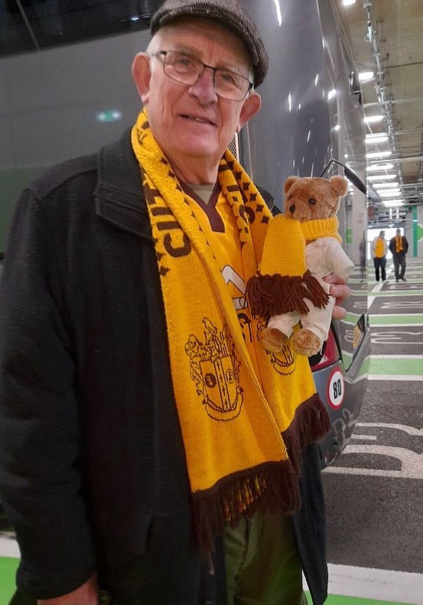 Bobby holding Brooklands Bertie - both with their Sutton United scarves.