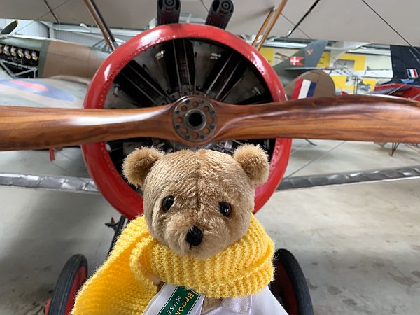 Brooklands Bertie in front of a plane and its propellor.