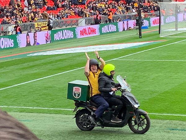 Tim Vine arriving on the back of a Papa Johns delivery bike.