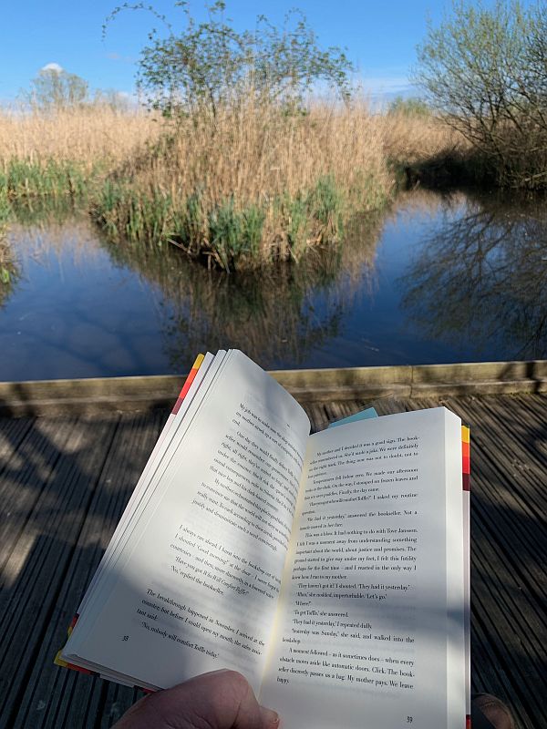 Bobby's book as he is sat on a bench on the boardwalk.