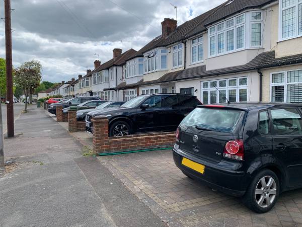 Cars parked on the former front gardens in Brocks Drive.