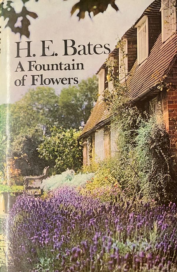 The front cover of H E Bates book "A Fountain of Flowers" with a cottage and flower garden.