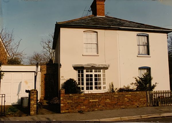 Laurel Cottage in 1999. Plain walls with no climbing plants, with a driveway and garage to the left.