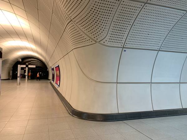 Elizabeth Line passenger tunnels. Plain, but bright, spacious and airy.