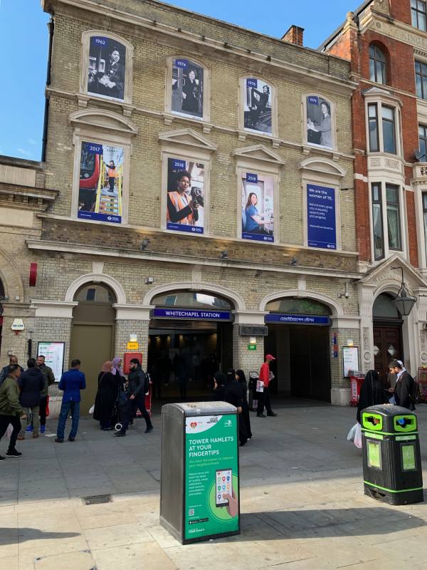 The historic exterior of Whitechapel Station, with the name in both English and Arabic.