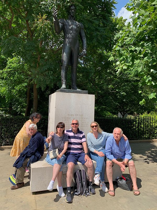 More people sat on the plinth of Simon Bolivar's statue.