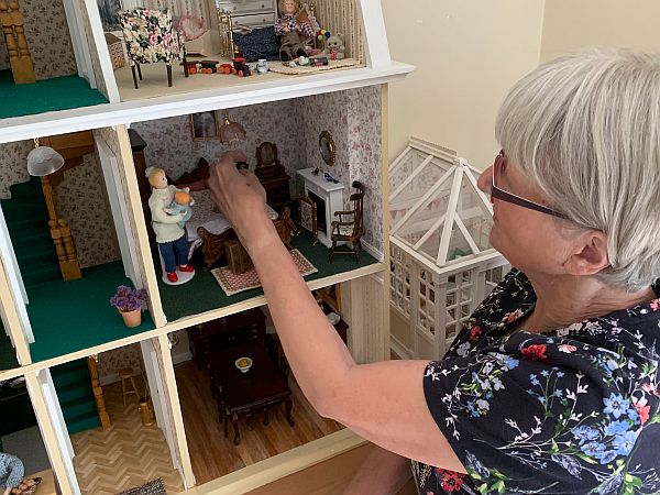 Gill arranging a room in the Dolls House.