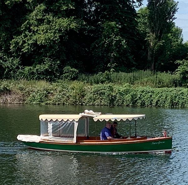 Couple cruising in a motor launch on the Thames.