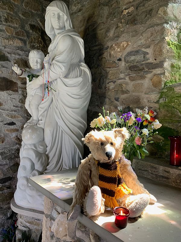 Bertie and a candle lit for Diddley in St Non's Chapel, St David's.