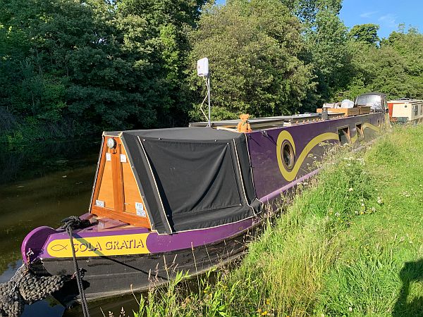 Eamonn on the roof of Purple and Yellow Narrowboat Sola Gratia moored up on the Grand Union Canal at Ladbroke Grove.