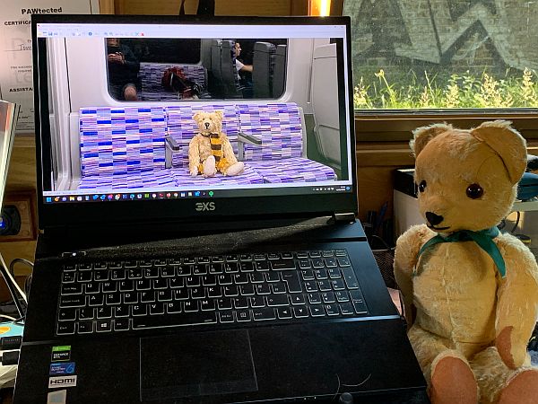 Eamonn sat beside the Mindfully Bertie laptop, with a picture of Bertie on an Elizabeth Line train.