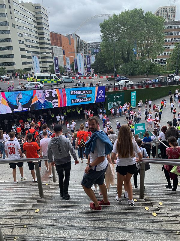 Football crowds going down the steps of Wembley Park Station.