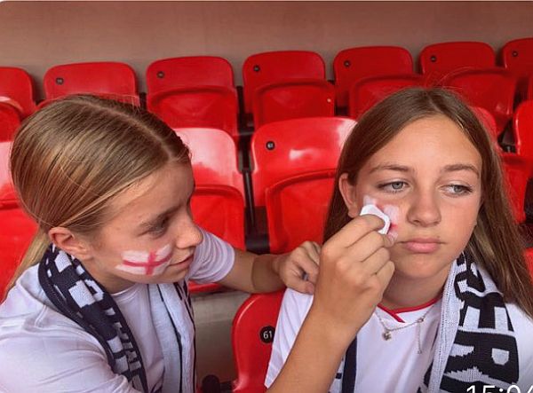 Applying face-painted England cheek flags.