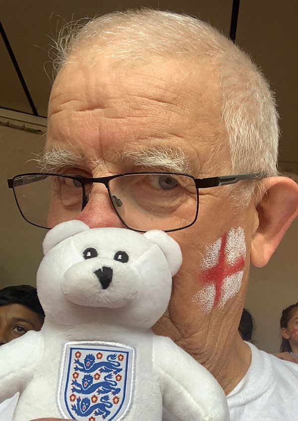 Bobby with England flag face-painted on his cheek, with Ellen in front of his face!
